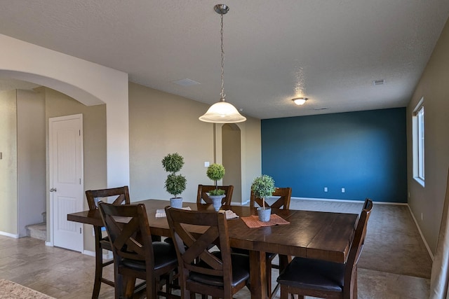 dining room featuring a textured ceiling