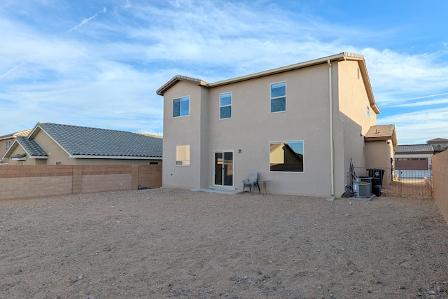 back of house featuring central AC