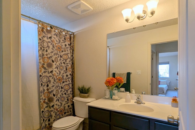 bathroom with vanity, curtained shower, toilet, and a textured ceiling