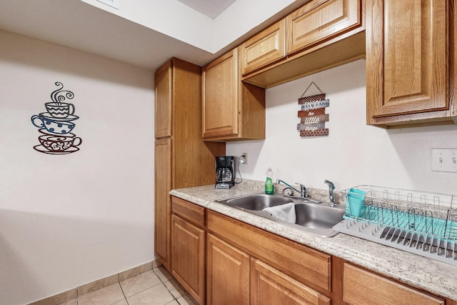 kitchen featuring sink and light tile patterned floors