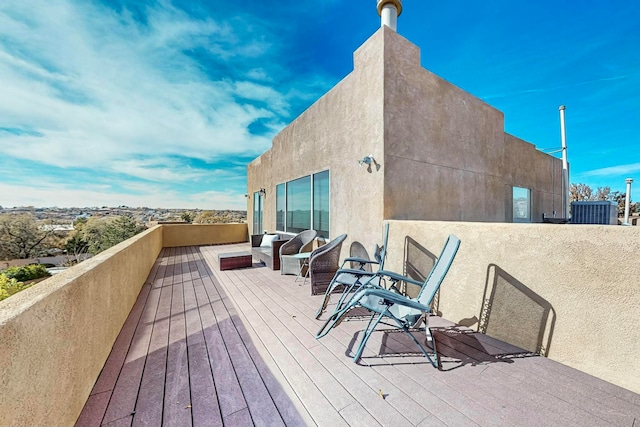 wooden terrace featuring cooling unit