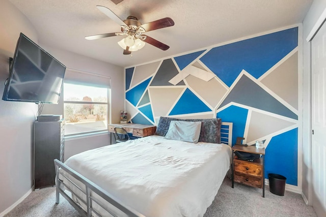 carpeted bedroom with ceiling fan, a closet, and a textured ceiling