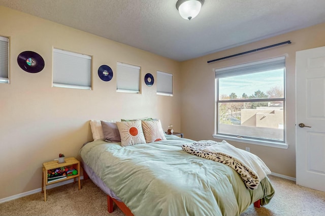 bedroom featuring a textured ceiling and carpet floors