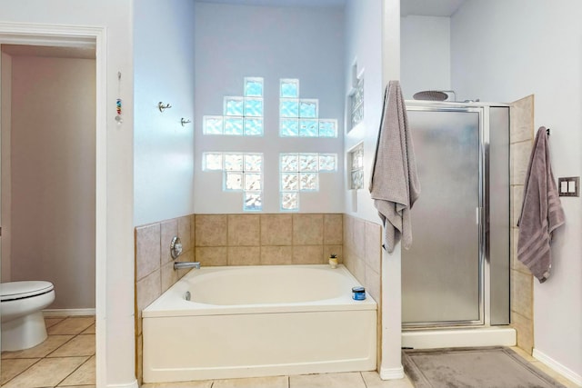 bathroom with tile patterned floors, plus walk in shower, and toilet