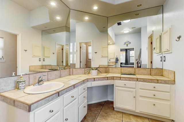 bathroom featuring tile patterned flooring, vanity, and tasteful backsplash