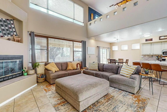 living room with light tile patterned floors, sink, and a wealth of natural light