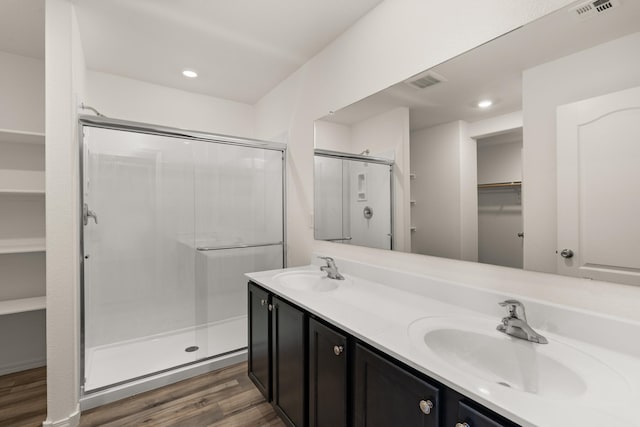 bathroom featuring hardwood / wood-style floors, vanity, and an enclosed shower