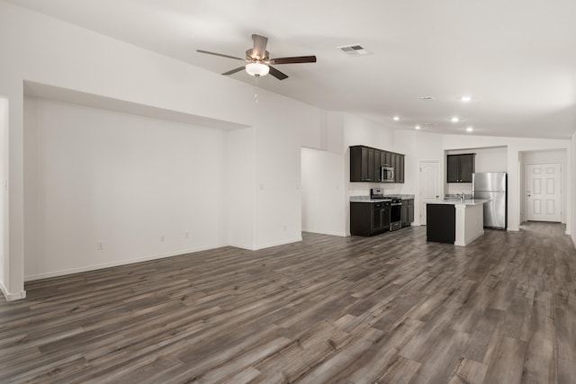 unfurnished living room with dark hardwood / wood-style floors, ceiling fan, lofted ceiling, and sink