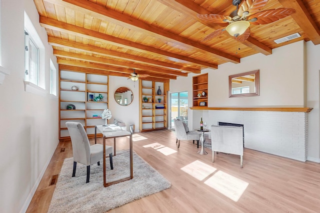 home office with light hardwood / wood-style floors, wooden ceiling, and beam ceiling