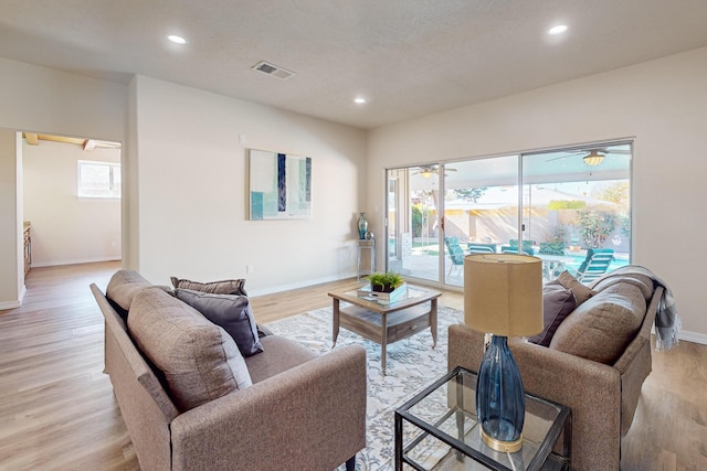 living room with a wealth of natural light and light hardwood / wood-style floors