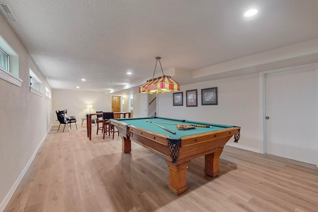 playroom featuring light wood-type flooring, a textured ceiling, and pool table