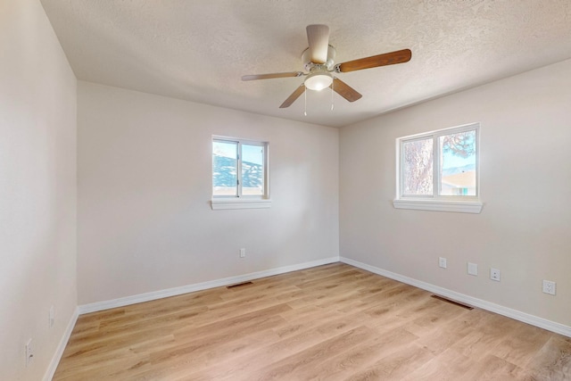 spare room featuring ceiling fan, a textured ceiling, and light hardwood / wood-style flooring