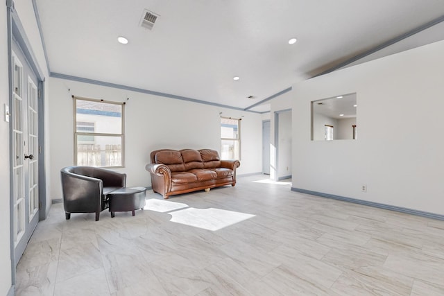 living room featuring french doors, lofted ceiling, and crown molding