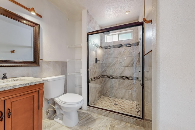 bathroom with vanity, an enclosed shower, a textured ceiling, and toilet