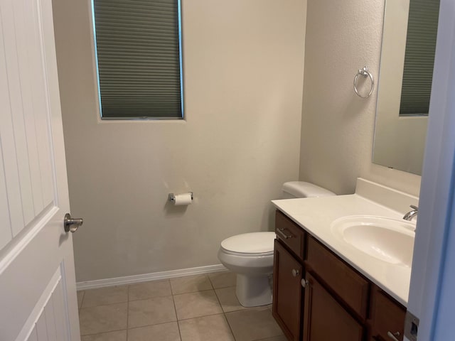 bathroom with tile patterned flooring, vanity, and toilet