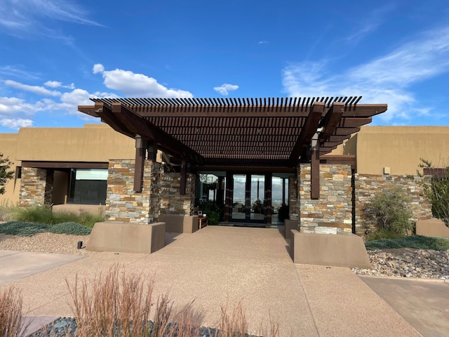 exterior space with french doors and a pergola