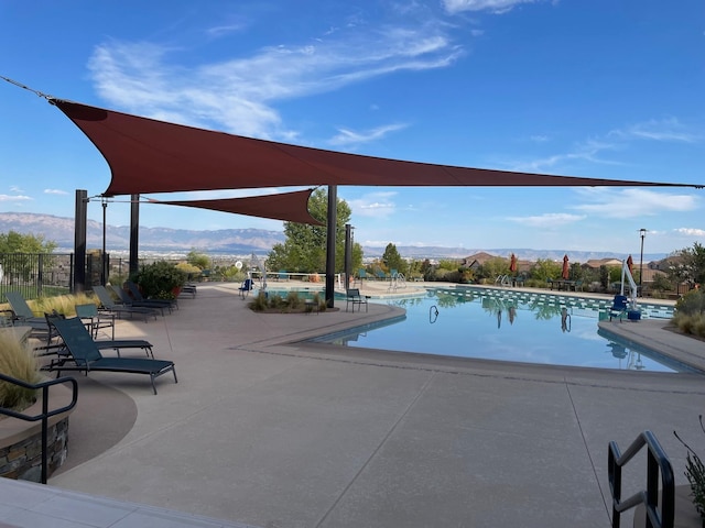 view of pool featuring a mountain view and a patio