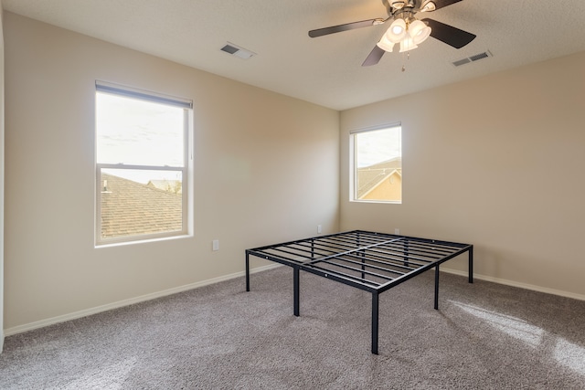 game room with carpet flooring, a textured ceiling, and ceiling fan