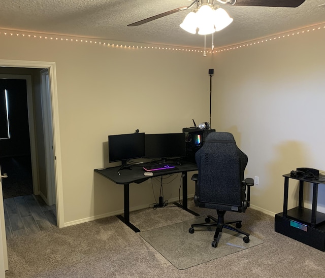 office area featuring carpet, ceiling fan, and a textured ceiling