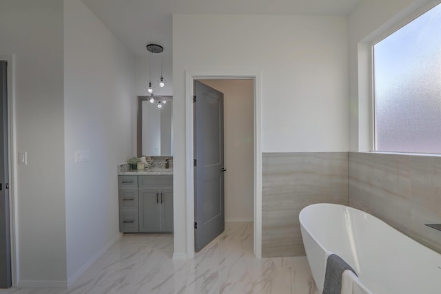 1109 11th St SE, Rio Rancho, NM 87124 - bathroom with baseboards, marble finish floor, a freestanding tub, and vanity