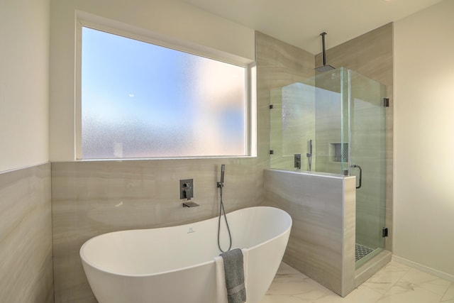 1109 11th St SE, Rio Rancho, NM 87124 - bathroom with tile walls, marble finish floor, a freestanding tub, and a shower stall