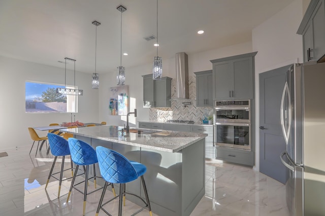 1109 11th St SE, Rio Rancho, NM 87124 - kitchen with stainless steel appliances, marble finish floor, a sink, visible vents, and wall chimney exhaust hood