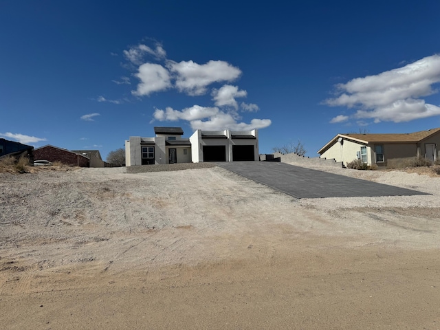 1109 11th St SE, Rio Rancho, NM 87124 - exterior space featuring driveway and a garage