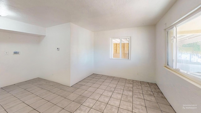 unfurnished room with light tile patterned floors