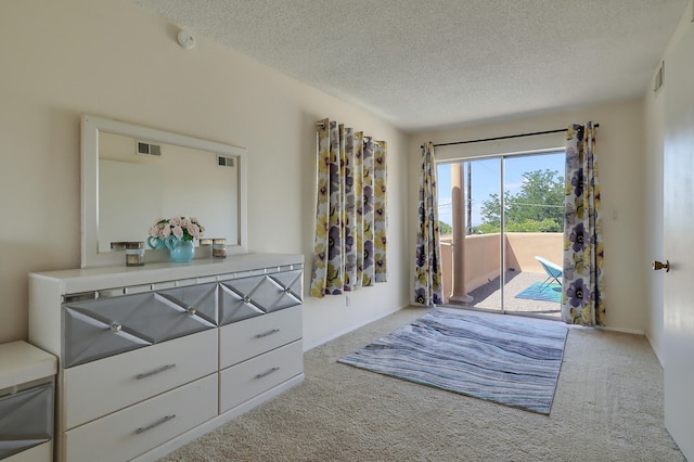 entryway with light colored carpet and a textured ceiling