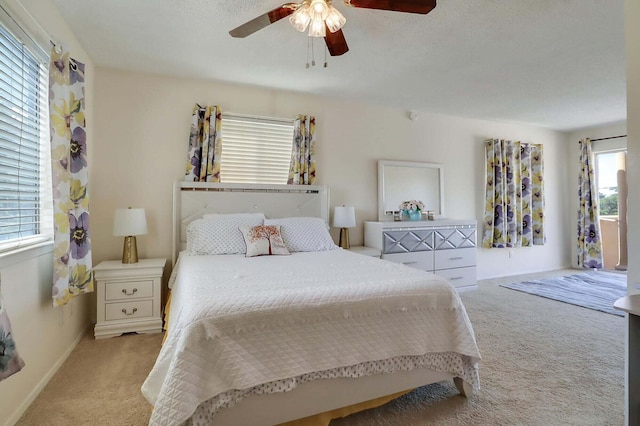 carpeted bedroom with a textured ceiling and ceiling fan