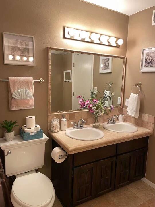 bathroom featuring tile patterned flooring, vanity, and toilet