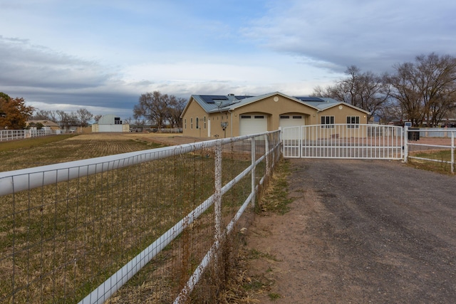 view of front of house with a garage and solar panels