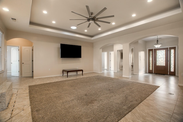 170 Esperanza Dr, Bosque Farms, NM 87068 - unfurnished living room with recessed lighting, baseboards, a raised ceiling, arched walkways, and a ceiling fan