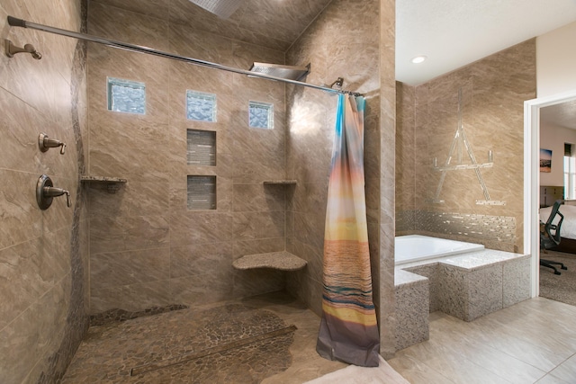 bathroom featuring tile patterned flooring and shower with separate bathtub