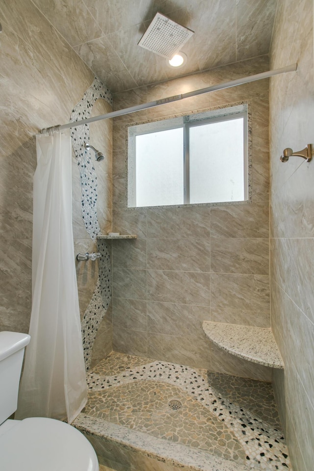 bathroom featuring toilet and a shower with shower curtain