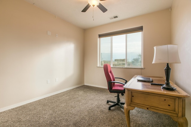 carpeted office space with ceiling fan