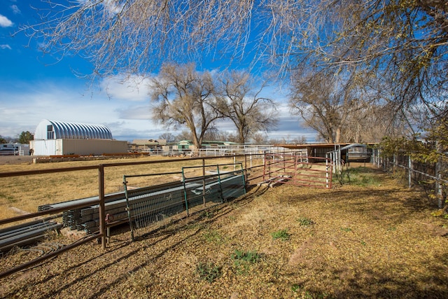 view of yard featuring an outdoor structure and a rural view