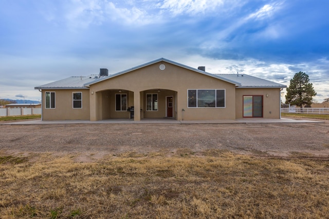 back of property with a patio