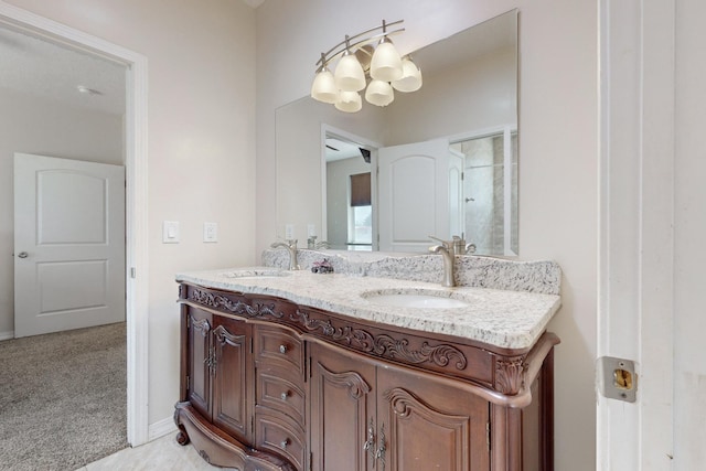 170 Esperanza Dr, Bosque Farms, NM 87068 - bathroom featuring baseboards, a notable chandelier, and vanity