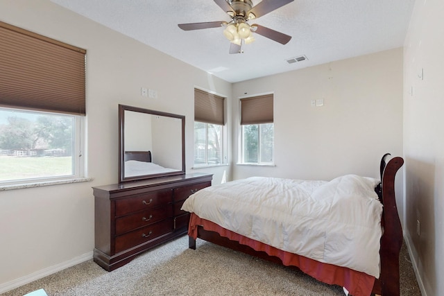 170 Esperanza Dr, Bosque Farms, NM 87068 - bedroom with light colored carpet, a ceiling fan, a textured ceiling, baseboards, and visible vents
