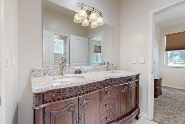 bathroom featuring vanity, a chandelier, and a wealth of natural light