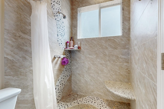 bathroom with curtained shower and toilet