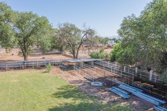 view of yard with an outbuilding and a rural view