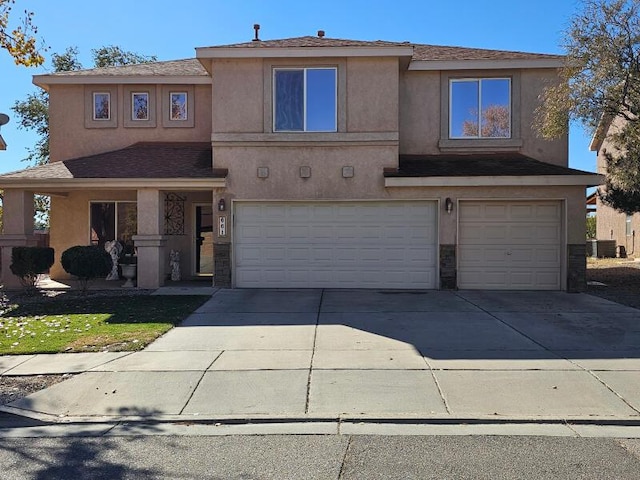 view of front of property with a garage and cooling unit