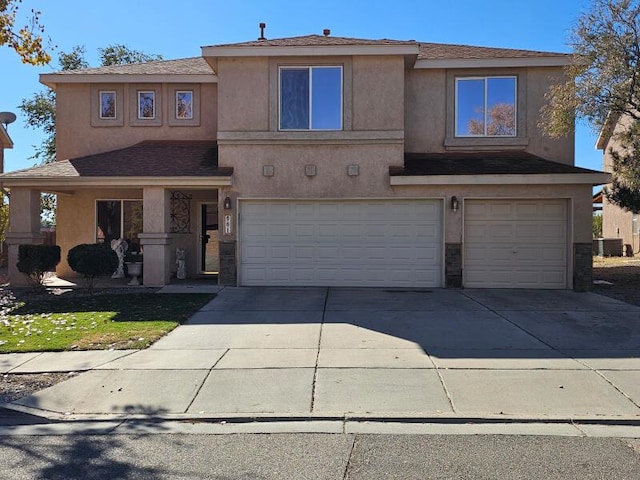 view of front of property with central AC and a garage