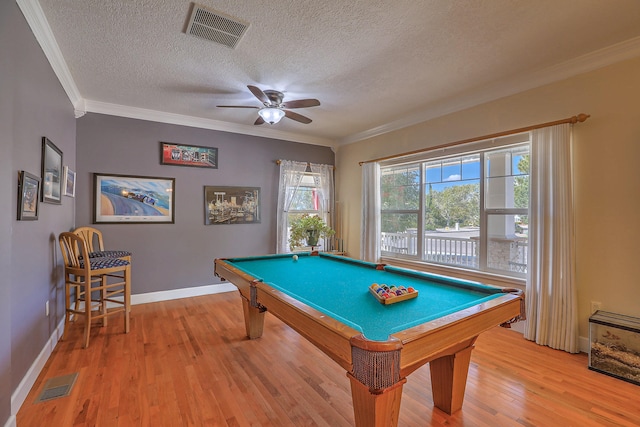 rec room featuring wood-type flooring, a textured ceiling, ornamental molding, and billiards