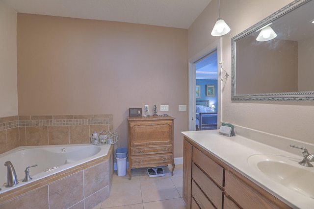 bathroom with tile patterned flooring, vanity, and tiled tub