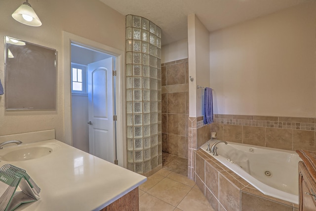 bathroom featuring tile patterned flooring, vanity, and shower with separate bathtub