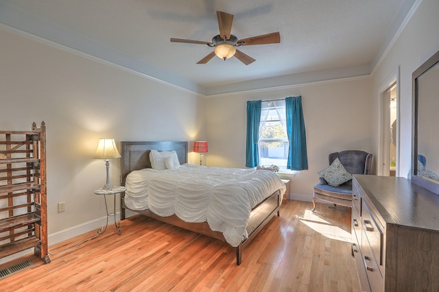 bedroom featuring light hardwood / wood-style flooring, ceiling fan, and ornamental molding