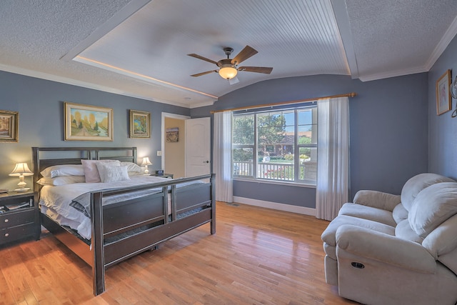 bedroom featuring a textured ceiling, ceiling fan, light hardwood / wood-style flooring, and vaulted ceiling